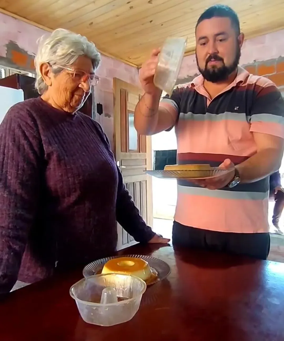 Clair e a nona, com o pudim na mesa